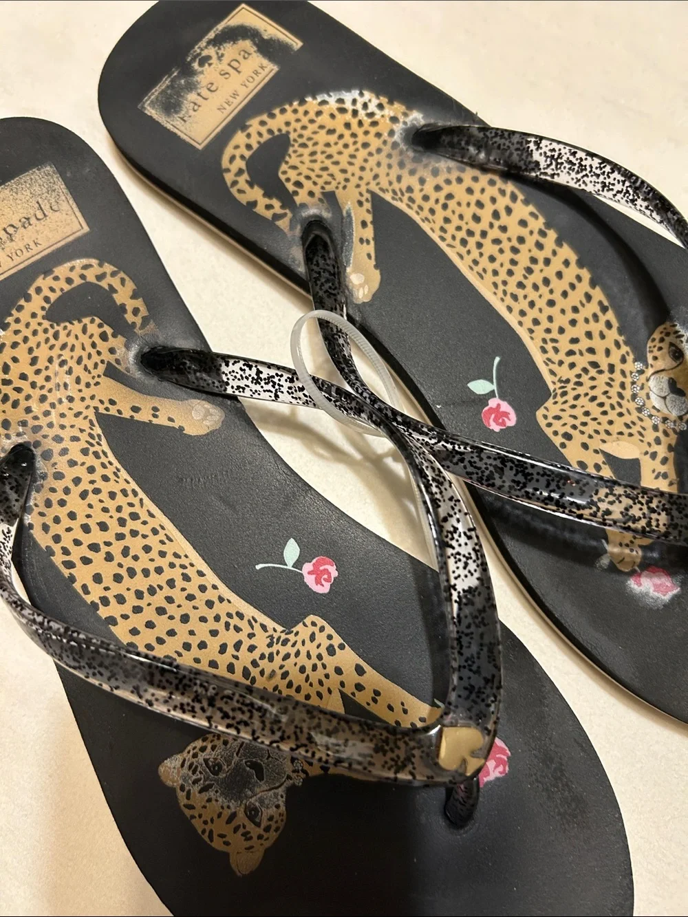 kate spade Black Leopard Print Flip Flop Sandals with Pink Floral Accent